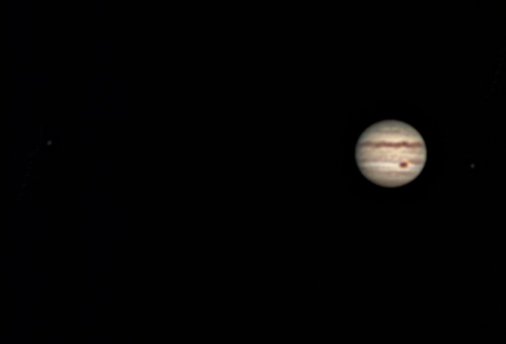 Jupiter with moons Europa (left) and Io (right)