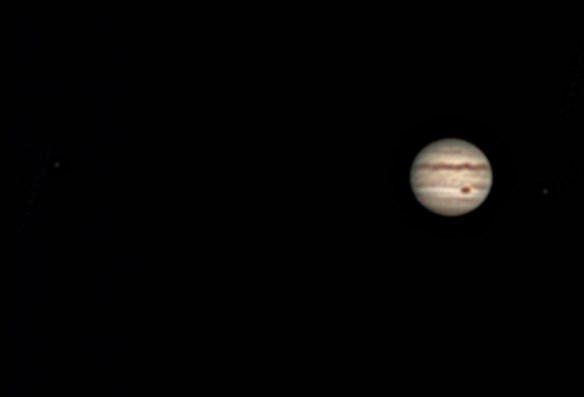 Jupiter with moons Europa (left) and Io (right)